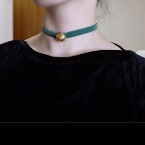 One Givenchy clip earring with green velvet choker